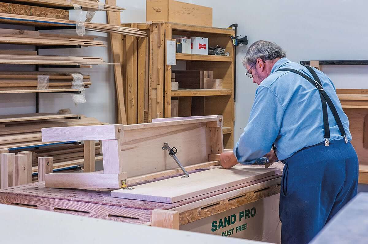 Amish Furniture Craftsman working on a new design