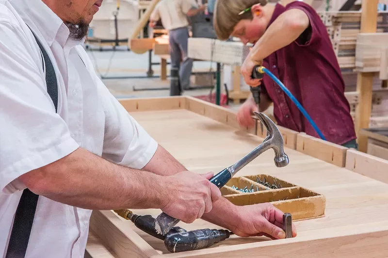 Amish craftsman building furniture by hand